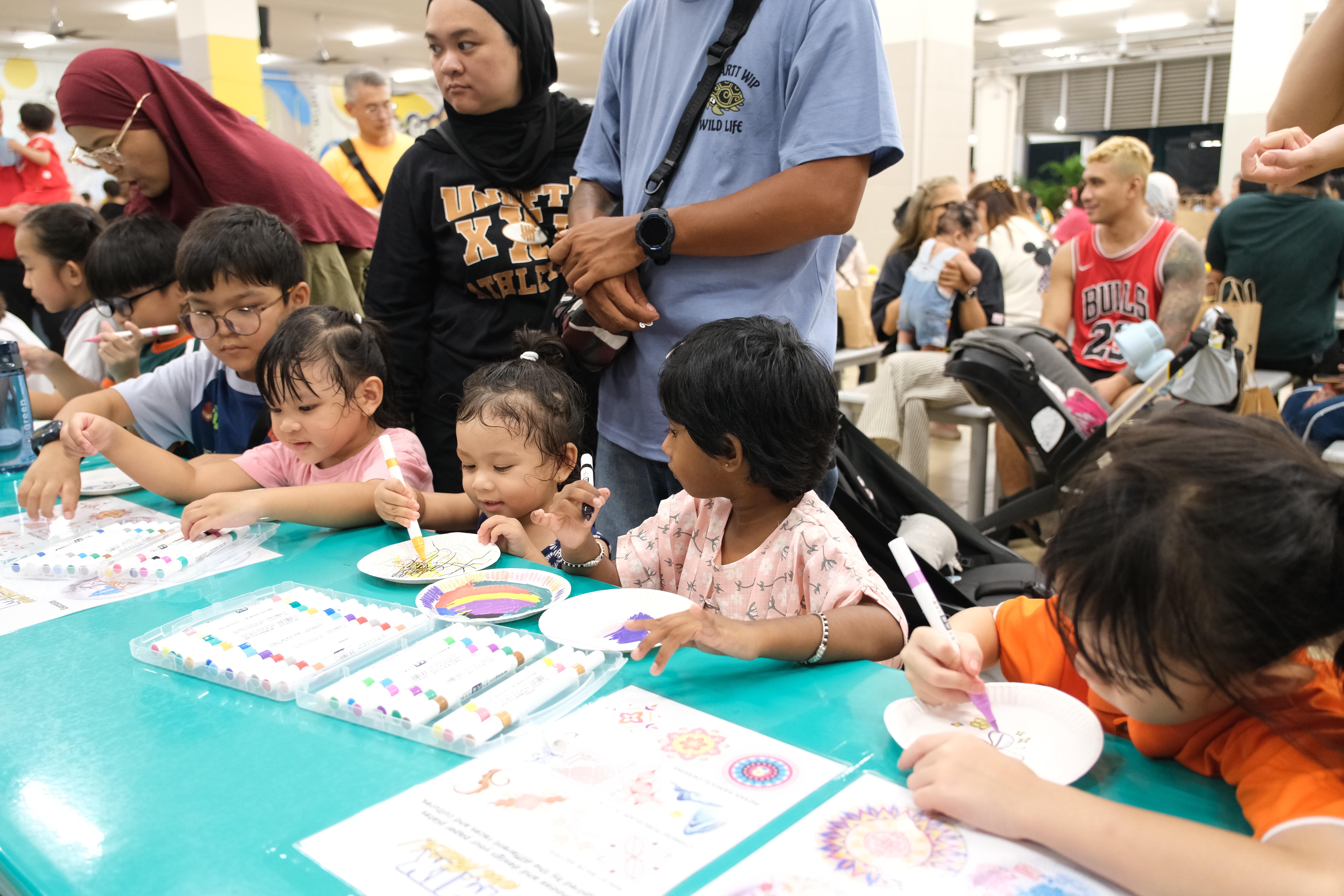 Little hands, big creativity! Our young participants add their own colourful touch to the cultural festivities.